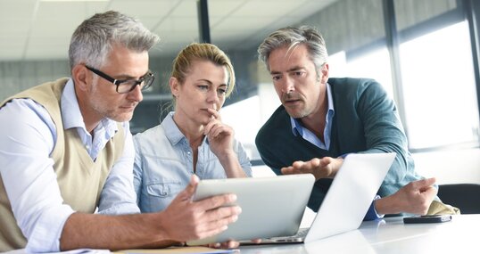 Business people in a meeting using tablet