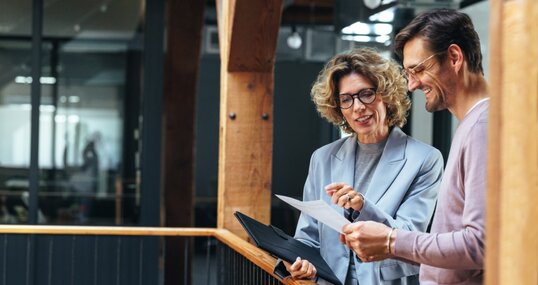 Business people analysing a financial report together. Two business people discussing in an office